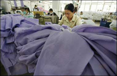 A woman works at a textile mill on the outskirts Shenzhen. China warned the European Union bilateral trade relations could be affected if the bloc goes ahead with plans to impose limits on Chinese textile exports, as it reaffirmed its opposition to the move(AFP