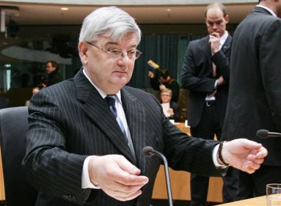 German Foreign Minister Joschka Fischer reaches out to adjust the microphones as he takes his seat at the start of a parliamentary panel investigating a visa scandal that has sapped his popularity in Berlin on Monday, April 25, 2005. Parliament is holding hearings on a 2000 easing of visa rules that the opposition says allowed criminals and women forced into prostitution to enter Germany. (AP