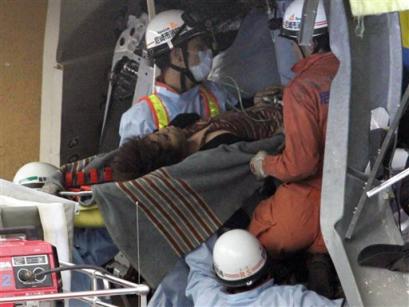 A survivor is rescued, nearly a day after a train accident in Amagasaki Tuesday morning, April 26, 2005. A packed commuter train jumped the tracks on Monday and hurtled into an apartment complex, killing at least 71 people and injuring more than 440 others in the deadliest Japanese rail accident in four decades. (AP 