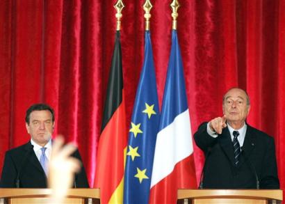 French President Jacques Chirac, right, points at a reporter as he and German Chancellor Gerhard Schroeder hold a press conference at the Elysee Palace in Paris Tuesday April 26, 2005, after a joint meeting of the French and German cabinets to discuss economic cooperation and the European Union constitution. Polls show the French could reject the treaty in a May 29 referendum. (AP