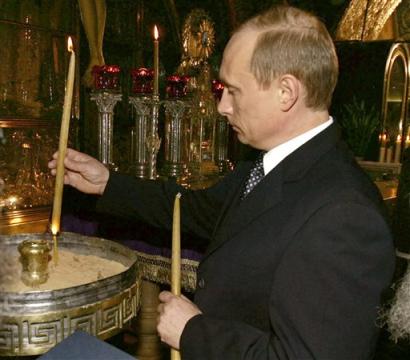 Russian President Vladimir Putin lights a candle, as he visits the Church of the Holy Sepulchre, believed to be built on the site of Jesus' last resting place after his body was removed from the cross in the old town of Jerusalem, Wednesday, April 27, 2005. 