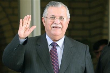 Iraqi President Jalal Talabani waves after meeting Arab Sunni Muslim tribal leaders of the Iraqi northern Salaheddin province at his house in Baghdad, Iraq, April 27, 2005.