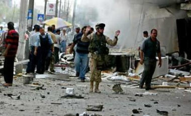 A U.S. soldier asks people to move back following a car bomb explosion in Baghdad May 2, 2005. The U.S. Army missed its goals for signing up recruits in April and expects to do so again in May, and the Marines also fell short, officials said on Monday, as the Iraq war further strained the all-volunteer U.S. military. (Faleh Kheiber/Reuters