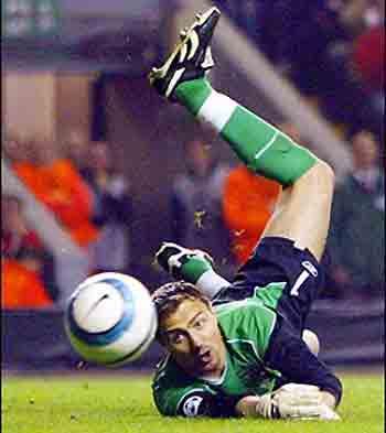 Diving block : Liverpool's goal keeper Jerzy Dudek dives to block a free kick from Chelsea's Frank Lampard during their second leg semi-final Champion's League football match at Anfield in Liverpool, England. Liverpool won 1-0 to advance to the final. (AFP