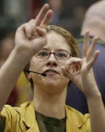 Clerk Renee Rosignol calls out a trade in the Euro Dollar Pit at the Chicago Mercantile Exchange, after the U.S. Federal Reserve nudged interest rates up for an eighth straight time, May 3, 2005. The Fed is nodding to mounting inflation pressures but still confident it can contain them with 'measured' increases. REUTERS