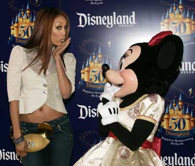 Supermodel Tyra Banks poses with Disney character Minnie Mouse during Disneyland's 50th anniversary party at the Disneyland theme park in Anaheim, California May 4, 2005. Walt Disney, founder of the Walt Disney Company and visionary behind the creation of Disneyland, opened the park on July 17, 1955. 