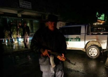 Afghan police secure a blast site in Kabul, Afghanistan May 7, 2005. A bomb at an Internet cafe in the Afghan capital of Kabul killed two Afghans and wounded five on Saturday, police said. REUTERS