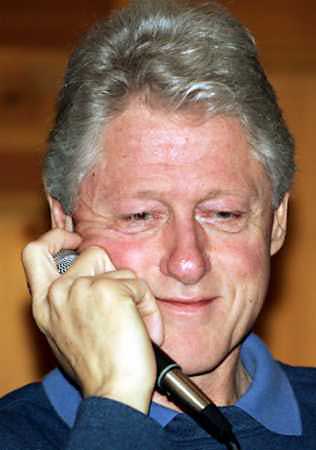 Former President Bill Clinton (news - web sites) reacts to a question from the media prior to playing in a charity golf event with former President George H. Bush and Greg Norman at the Medalist Golf Club in Hobe Sound, Florida, March 9, 2005. Clinton is expected to make a full recovery after surgery on Thursday to remove scar tissue and fluids from his chest just months after a heart-bypass operation, his doctors said. (Marc Serota/Reuters) 