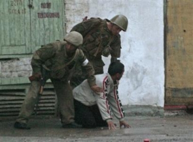 Uzbek soldiers 
 search a local resident at the square outside the administration building in downtown Andijan, Uzbekistan, Friday, May 13, 2005. [AP]
