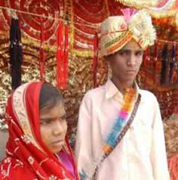 Eleven-year-old Rekha, left, stands with her groom Bheeram Singh, 16, after their marriage in Rajgarh, about 105 kilometers (65 miles), northwest of Bhopal, India, Thursday May 12, 2005. Ignoring laws that ban child marriages, hundreds of children, some as young as seven years old, were married in a centuries-old custom across central and western India this week. (AP