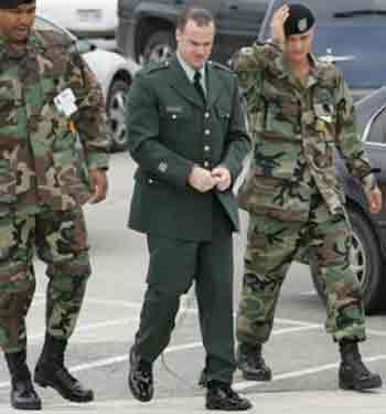 Pvt. Ivan L. Frederick, II, center, is escorted into the courthouse Thursday, May 12, 2005 in Fort Hood, Texas. Frederick, II, previously pleaded guilty at a general court-martial to charges involving prisoner abuse at Abu Ghraib prison in Iraq and is expected to testify in the trial of Spc. Sabrina D. Harman, which started Thursday. Harman is also facing charges in connection with prisoner abuse at the Abu Ghraib prison. She could face up to 6 1/2 years if convicted of conspiracy to maltreat detainees, five counts of maltreating detainees and dereliction of duty. (AP