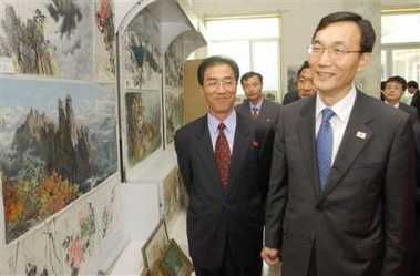 South Korean Vice Unification Minister Rhee Bong-jo, right, looks at landscapes of North Korea mountains with his North Korean counterpart Kim Man Gil, left, after their meeting at the North Korean border town of Kaesong, Monday, May 16, 2005.