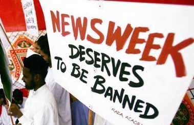 A Muslim boy holds a placard during an anti-U.S. demonstration in Bombay May 16, 2005. Newsweek on Monday retracted a report that claimed U.S. interrogators at Guantanamo Bay had desecrated the Koran, which triggered days of rioting in Afghanistan and other countries in which at least 16 people were killed. REUTERS