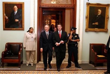 Senate Majority Leader Bill Frist, R-Tenn., right, exits the Senate chamber of the U.S. Capitol with Senate Minority Leader Harry Reid, D-Nev., left, in Washington Monday, May 23, 2005. 