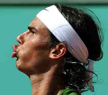 Fourth seed Rafael Nadal of Spain reacts after scoring a point against France's Richard Gasquet, the number 30 seed, during their match in the third round of the French Open tennis tournament at Roland Garros May 27, 2005. [Reuters]