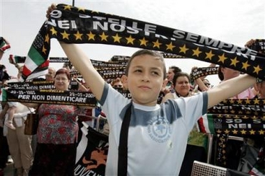 A Juventus soccer fan shows a scarf to remember the Heysel tragedy at the King Baudouin stadium in Brussels, Sunday May 29, 2005. Fans from Britain, Italy and Belgium marked the Heysel tragedy in which 39 soccer fans died with the unveiling of a statue, a poem and solemn tributes.