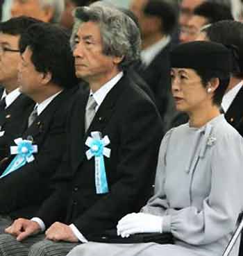 Japanese Prime Minister Junichiro Koizumi (C) sits with Princess Takamado (R) during a memorial service at Chidorigafuchi National Tomb for Dead Soldiers in Tokyo May 30, 2005, 