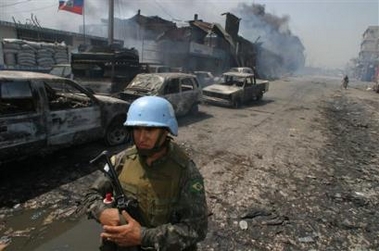 A U.N. Brazilian peacekeeper guards during a fire at a market in Port-au-Prince,Haiti on Wednesday, May 31, 2005.