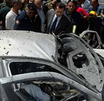Jubran Tuweini (C), a newly elected deputy to the Lebanese parliament, inspects the damaged car of journalist Samir Qaseer in Beirut June 2,2005. Samir, a prominent anti-Syrian journalist of An-Nahar newspaper, was killed on Thursday when a bomb destroyed his car as he started the engine in a Christian district of Beirut, security sources said. They said he died instantly in the blast that destroyed his white Alfa Romeo car outside his home in the Ashrafiyeh neighbourhood. A woman was wounded. [Reuters]