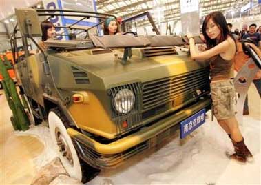 In a file photo models pose next Nanjing IVECO Motors' NJ2046sDG5 4x4 car on display Wednesday April 27, 2005 at Auto Shanghai 2005 exhibition in Shanghai, China. Industrywide, sales of passenger vehicles in China rose 15.7 percent in April over last year's numbers, as car buyers returned to the market after hanging back earlier in the year in hopes of further price cuts, according to the China Automobile Manufacturers Association. (AP 
