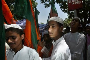 Muslim protesters belonging to the minority wing of Hindu nationalist Bharatiya Janata Party hold their party flags at an anti-U.S. demonstration near the American Embassy in New Delhi, India, Thursday, June 2, 2005. More than 200 Muslim supporters staged a protest march on Thursday, demanding an apology from the Bush administration for the alleged Quran abuse by American interrogators at Guantanamo Bay prison in Cuba. (AP