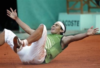 Spain's Rafael Nadal falls on the clay as he defeats top-seeded Switzerland's Roger Federer during their semifinal match of the French Open tennis tournament, at the Roland Garros stadium, Friday June 3, 2005 in Paris. Nadal won 6-3, 4-6, 6-4, 6-3. (AP