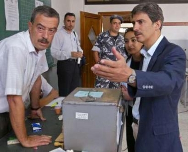 European Union's chief election observer Jose Ignacio Salafranca (R) talks to a Lebanese election official at a polling station in Nabatiyeh town in south Lebanon June 5,2005. 