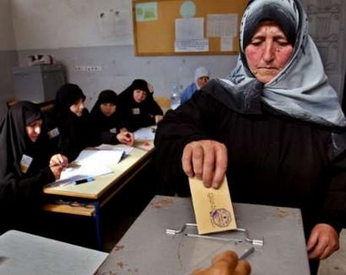 A female supporter of Lebanon's Hizbollah group casts her vote at a polling station in Jabsheet village, the heartland of Hizbollah, in south Lebanon June 5,2005.