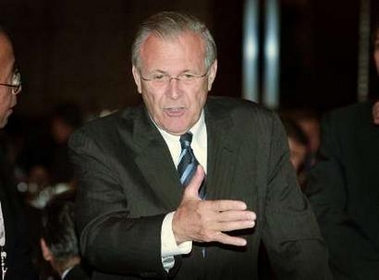 U.S. Secretary of Defense Donald Rumsfeld gestures as he chats with dignitaries before a dinner at a meeting of defence ministers from around the world in Singapore June 3, 2005. 