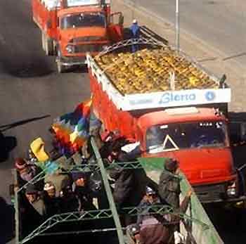 A truck with demonstrators leaves El Alto, Bolivia as trucks containing cooking gas moves towards La Paz, Bolivia on Saturday, June 11, 2005.