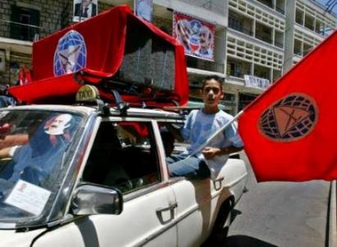 Lebanese supporters of Druze leader Walid Jumblatt wave a flag as they campaign in Aley town in Mount Lebanon June 11, 2005. Lebanon's elections, the first in three decades without a Syrian military presence, are being held in different regions over four weeks from May 29 to June 19. REUTERS