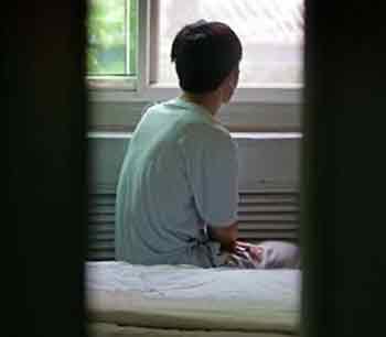A Chinese HIV positive patient looks out of the window from his hospital bed in the AIDS station of a hospital in Beijing June 6, 2005. China, which was slow in acknowledging the AIDS epidemic, reported some 840,000 people living with HIV at the end of 2003. REUTERS