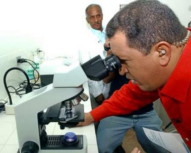 Venezuelan President Hugo Chavez looks through a microscope during his broadcast 'Alo Presidente' in Monagas state, 500km (300 miles) from Caracas, June 12, 2005.