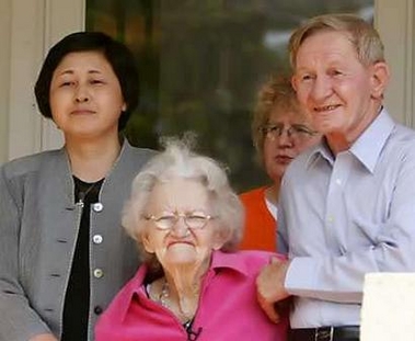 Charles Jenkins (R), a U.S. soldier who deserted his Army unit 40 years ago and fled to North Korea holds onto his 91-year-old mother Patty Casper (C) on the porch of his sister's home in Weldon, North Carolina June 14, 2005. With Jenkins is wife Hitomi Soga. Photo by Rick Wilking/Reuters
