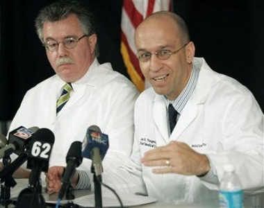 Dr. Jon Thogmartin, right, District 6 Medical Examiner, gestures as he gives a report with Dr. Stephen Nelson on Terri Schiavo's autopsy during a news conference Wednesday, June 15, 2005, in Clearwater, Fla. Schiavo's autopsy backed her husband's contention that she was in a persistent vegetative state, finding that she had massive and irreversible brain damage and was blind, the medical examiner's office said Wednesday. It also found no evidence that she was strangled or otherwise abused. (AP