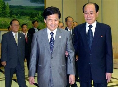 Kim Young-nam, right, chairman of the Standing Committee of the North Korean Supreme People's Assembly, escorts South Korean Unification Minister Chung Dong-young, center, to hold their meeting in Pyongyang, North Korea, Thursday, June 16, 2005.