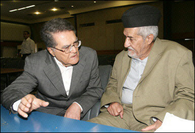 Picture dated June 8 shows Munzer al-Shawee (L) chatting with Adnan Dulaimi prior to the start of a meeting with some 150 Iraqi Sunni leaders in Baghdad. A deal was reached for Sunni Arabs to participate in a panel to draft the new constitution. [AFP/File]
