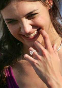 U.S. actress Katie Holmes smiles as she arrives for the French premiere of the latest movie 'War of the Worlds' with Hollywood film star Tom Cruise in Marseille June 17, 2005. The film opens in cinemas on June 29. Tom Cruise got engaged to actress-girlfriend Katie Holmes at the Eiffel Tower Friday, ending weeks of speculation over whether Hollywood's hottest couple would wed.