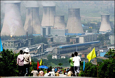 Residents walk down a road that leads to the county's power plant in Zhangjiakou, northeast China's Hebei province. A top Chinese environmental official has questioned whether China should embrace being the 'world's factory' and called for a 'green rise' to prevent ecological disaster, as the country 'has paid a high environmental price' for 20 years of rapid economic development.(AFP)