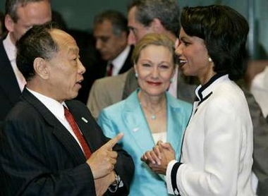 Chinese Foreign Minister Li Zhaoxing (L) talks with U.S. Secretary of State Condoleezza Rice (R) as European External Affairs Commissioner Benita Ferrero-Waldner (C) watches at the European Council headquarters at the start of an international conference in Brussels June 22, 2005. Washington and the European Union joined forces on Wednesday to rally international help for Iraq at a conference that will press Baghdad to ensure minority Sunnis play a full role in its future. REUTERS