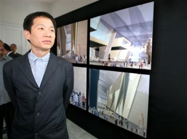 Irish Shih-Fu Peng of the Dublin firm Heneghan poses in front of his designs of the new Egyptian museum during a display in Cairo Wednesday June 22, 2005, marking the beginning of the US$350 million (289 million euro) project expected to open in 2008. Peng created a modern, desert-hugging design with a roof line reflecting the three 4,000-year-old pyramids. (AP