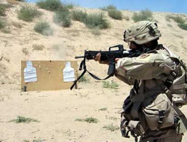A U.S. army soldier fires his weapon during an exercise at the Kandahar airbase in Afghanistan June 18, 2005.