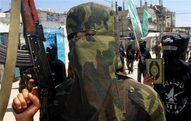 Palestinian masked militants from Ahmed Abu El Rish Brigades, a militant group linked to Fatah, march during a demonstration demanding the release of Palestinian prisoners being held in Israeli jails in the Rafah refugee camp, southern Gaza Strip, Thursday, June 23, 2005. Palestinian officials said Thursday that they have reached a tentative agreement to absorb about 700 gunmen in the West Bank city of Nablus into the Palestinian security services, pushing forward with a campaign aimed at disarming rogue militants roaming the Palestinian areas.(AP