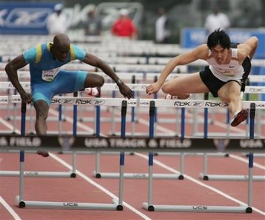 Allen Johnson, left, and China's Xiang Liu clear a barrier in the 110 meter hurdles at the Reebok/NYC Grand Prix in New York, Saturday, June 11, 2005. Johnson won the race, Xiang finished third. (AP