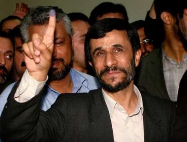 Iranian presidential candidate Mahmoud Ahmadinejad shows his ink-stained finger after casting his ballot in Tehran June 24, 2005. 