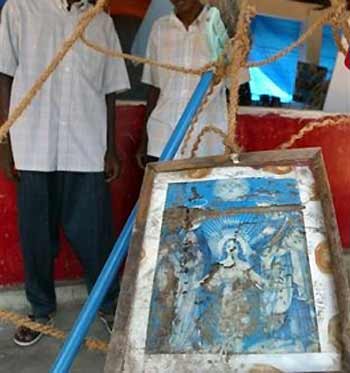 A picture of the holy family, which was recovered from a tsunami affected house, is put up as part of an exhibition to mark the six-month anniversary of the 2004 tsunami at Tamil rebel-controlled town of Vakarai, about 280 kilometers (175 miles) east of Colombo, Sri Lanka, Sunday, June 26, 2005. 
