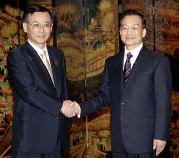 Chinese Premier Wen Jiabao (R) shakes hands with Japanese Finance Minister Sadakazu Tanigaki during a meeting in Tianjin, a municipality in north China, June 26, 2005.