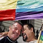 Supporters of gay marriage celebrate under the gay flag outside the Spanish parliament in Madrid, Thursday, June 30, 2005. 