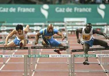 France's Ladji Doucoure (R) takes a hurdle as he goes on to win the men's 110m hurdles against Dominique Arnold (C) of the U.S. and China's Liu Xiang at the Paris Golden League meeting at the Stade de France in Saint Denis, near Paris July 1, 2005. 