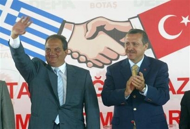 Turkish Prime Minister Recep Tayyip Erdogan, right, and his Greek counterpart Kostas Karamanlis cheer after a ceremony at the Turkey-Greece border in Tekirdag, northwestern Turkey, Sunday July 3, 2005. The two leaders inaugurated construction of a Turkey-Greece natural gas pipeline. The pipeline from Bursa Turkey to Komotini Greece is expected to be operational in 2006. (AP